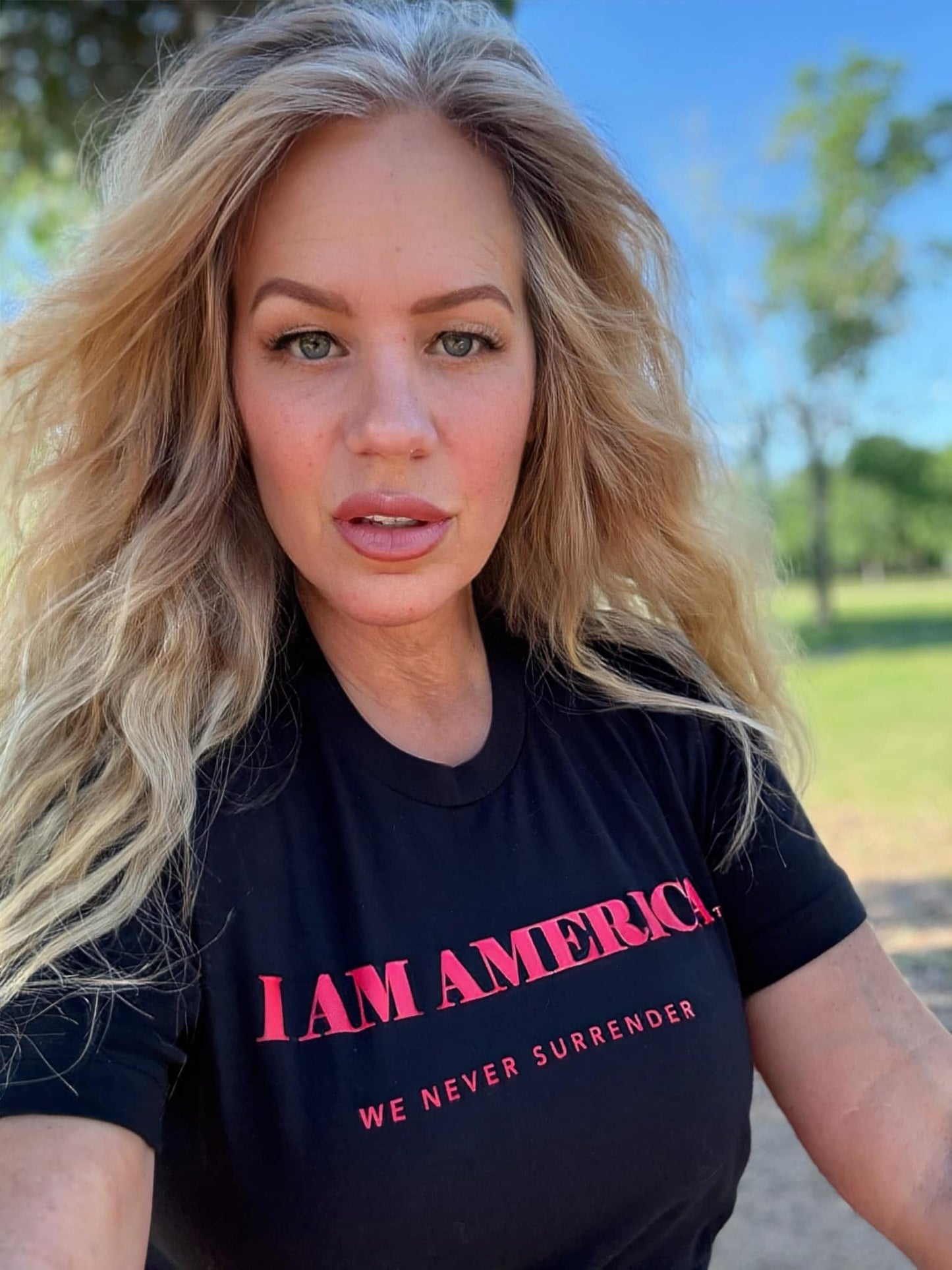 WE NEVER SURRENDER TM - IN WHITE PRINT